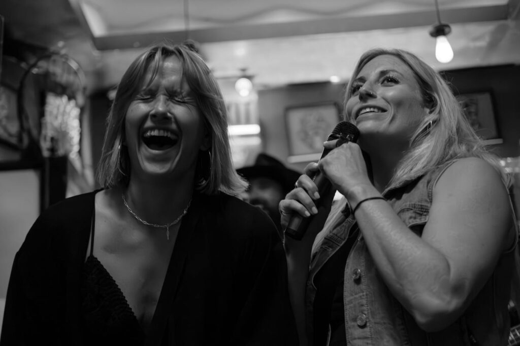 Cheerful Women Having Fun with Karaoke