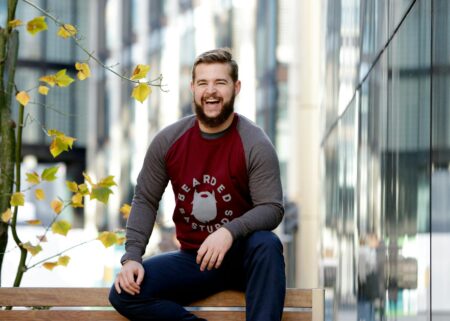 Man Sitting on Brown Wooden Bench