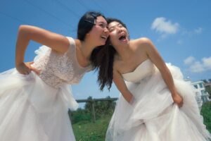 Women in White Wedding Dresses Laughing