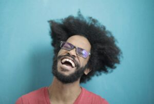 Man in Red Crew Neck Shirt Wearing Black Framed Sunglasses