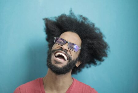 Man in Red Crew Neck Shirt Wearing Black Framed Sunglasses