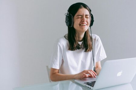 Woman In White Crew Neck T-shirt Using Macbook Pro