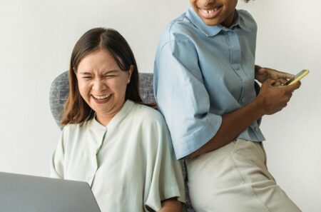 Two Women Laughing on an Armchair