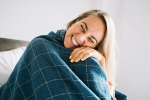 Woman in Blue Blanket Smiling