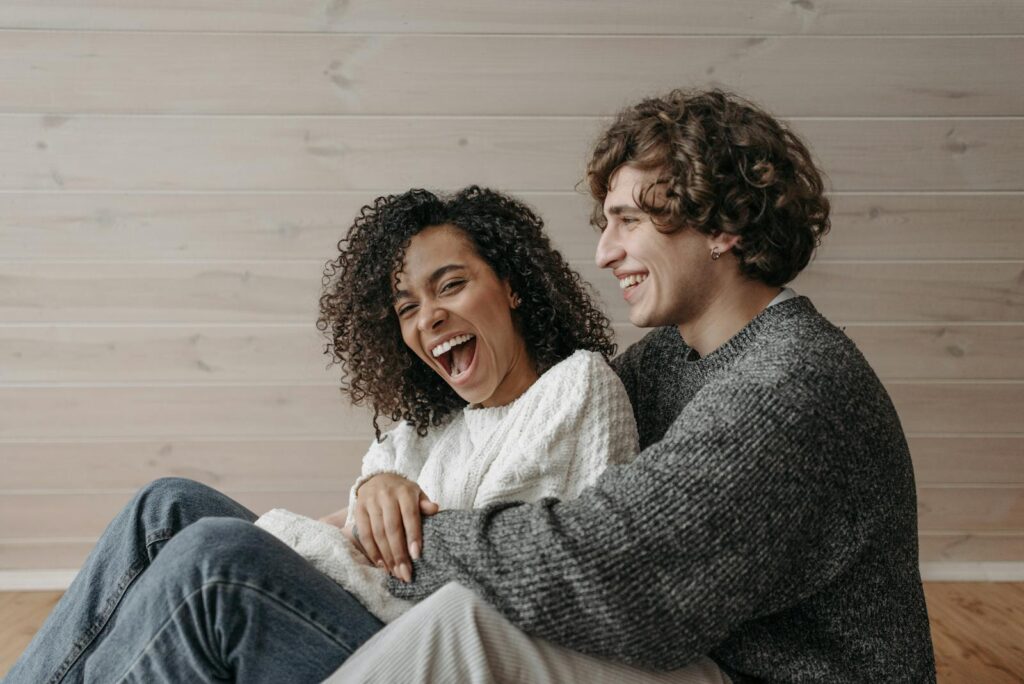 A Happy Couple Sitting Close Together on the Floor