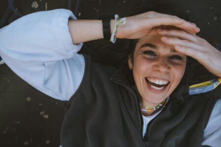 A Woman in Gray and White Jacket Laughing