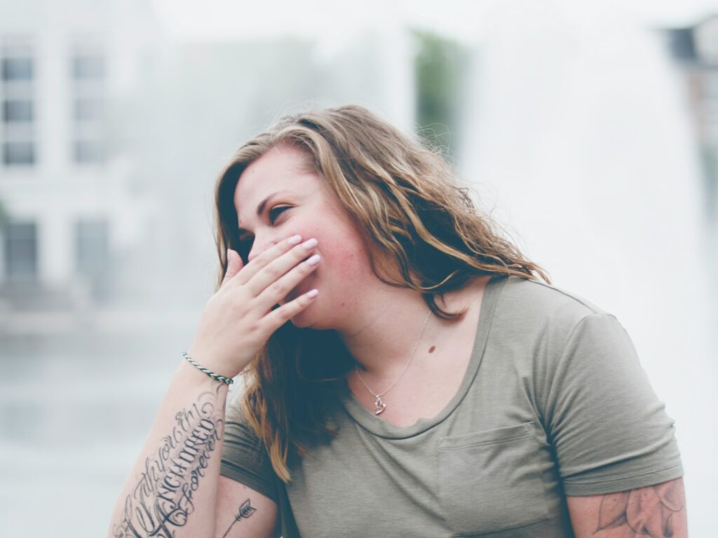 woman covering her mouth