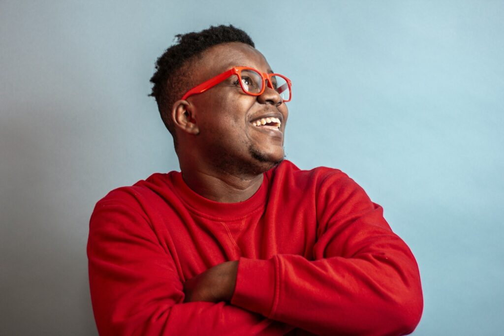 man in red sweater wearing black framed eyeglasses