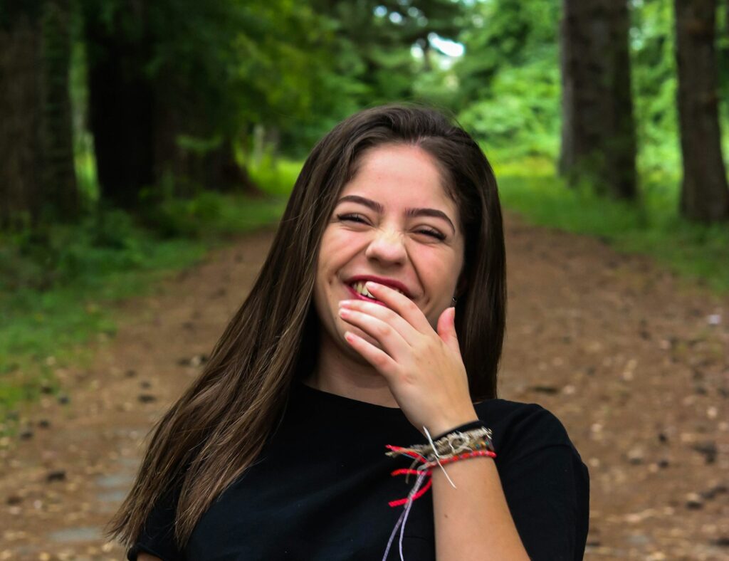 woman in black shirt wearing red beaded necklace