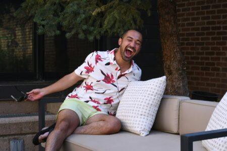 a man sitting on a couch with his mouth open